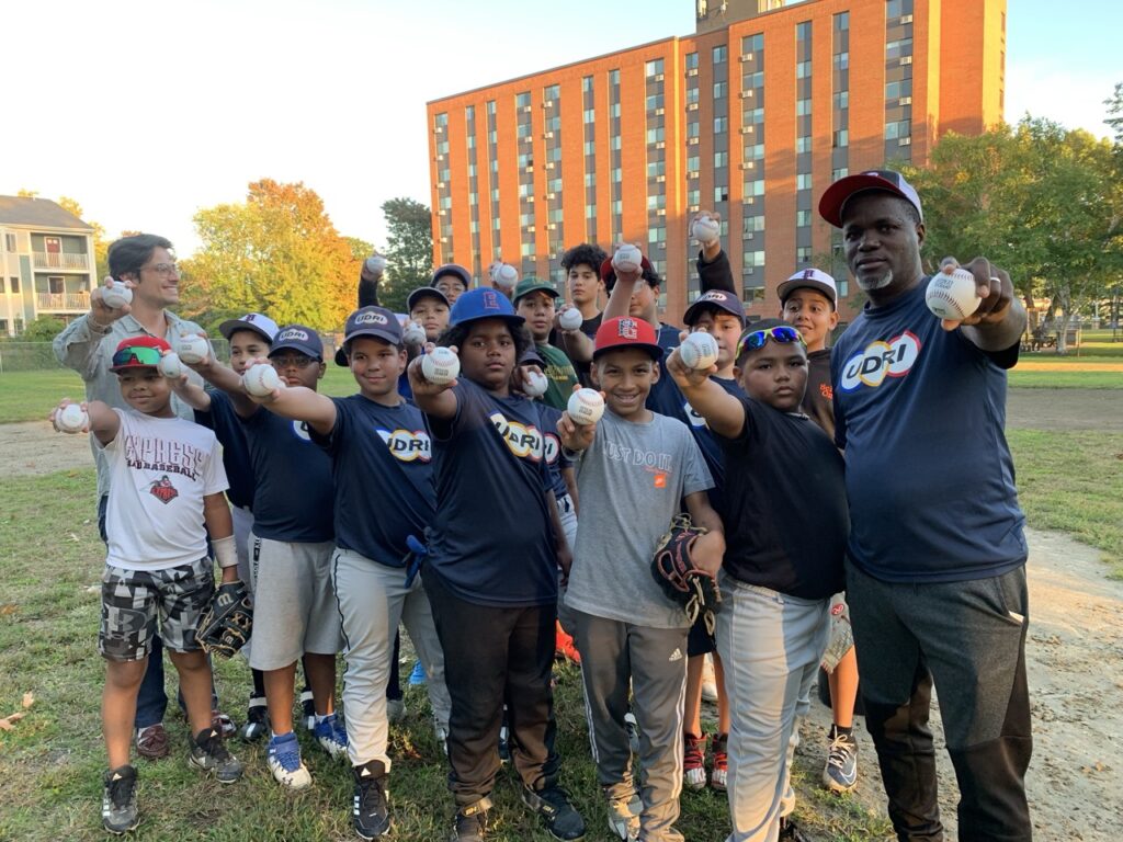 Diego shaking hands with a neighbor at a community event